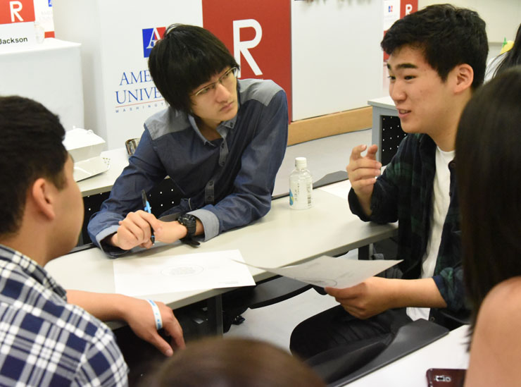 Students in a group sharing their thoughts on the key concepts of 'global' and 'international'