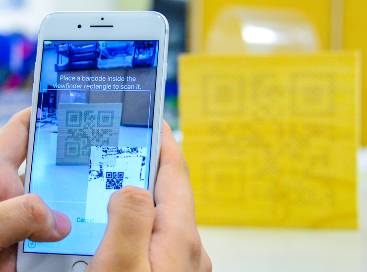 Capturing an image of the new 'Porous Code' engraved into a wooden block using a smartphone