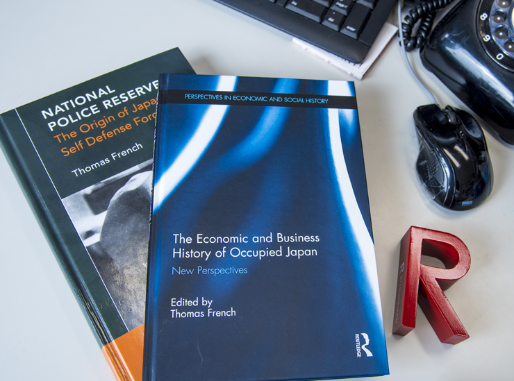 Professor French - two publications laid on the professors desk with a Ritsumeikan R mark book end