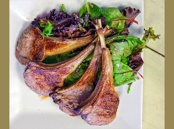 Four delicious lamb chops served on a bed of fresh baby leaf salad