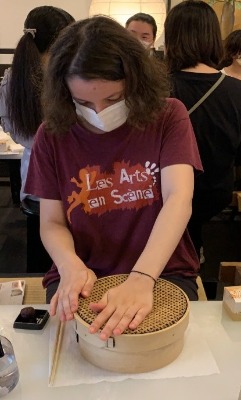 One student prepares a candy basket