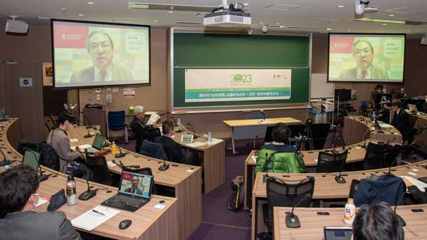 Director Nakatani delivering his address (on the screen)